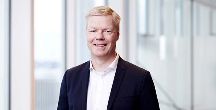 René Overgaard Jensen, Chief Transformation & Information Officer and Executive Vice President of Digital, Strategy & Transformation at Hempel in a suit.
